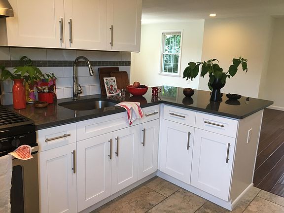 open-kitchen layout, with stone counter tops and custom wood cabinets