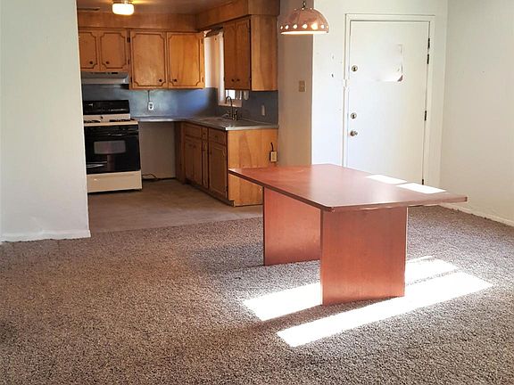 Living/dining room with view to kitchen (table pictured will not stay)