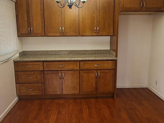 Dinning area with new floors and cabinets .