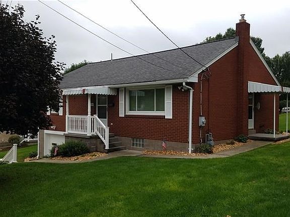 An angle view of the home from the right side showing the side porch.