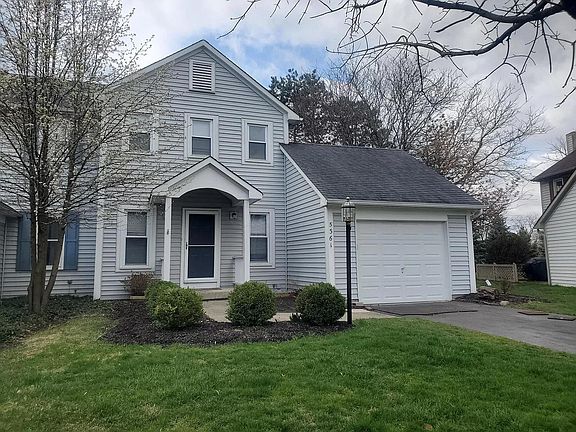 Front of the home with attached, single car garage. Lawn mowing and snow plowing provided by HOA.