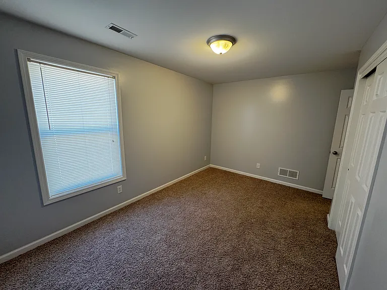 Second bedroom well suited for children with a spacious double sliding door closet.