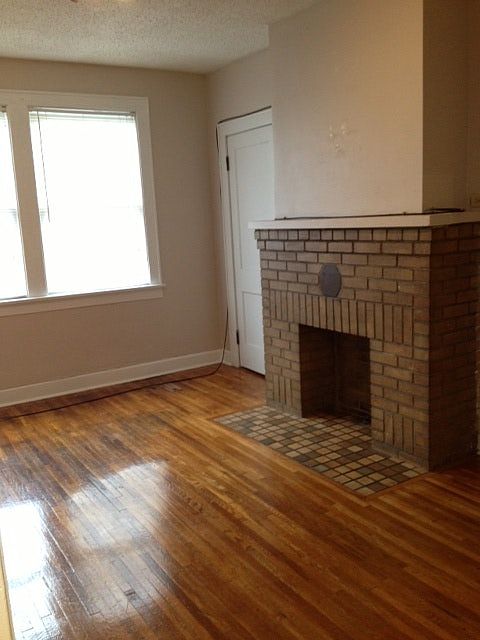 Decorative fireplace and hardwood floors