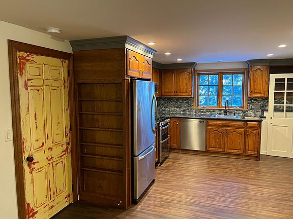Master bedroom door on left with entry door open on far right.
