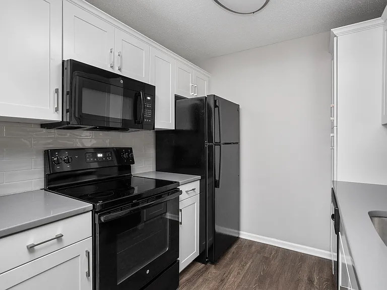 Updated kitchen with white cabinets and quartz countertops