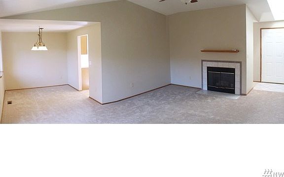 Vaulted living rm, skylighted entry, dining area and gas log fireplace.