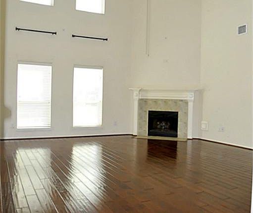 Family Room With 2 Story Ceilings*Wood Floors*Great Fireplace*Wall Of Windows For Natural Light.