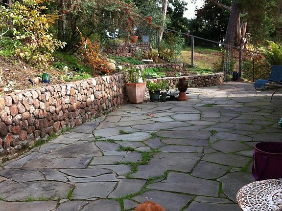 Beautiful flagstone patio with plenty of space for lounging and dining. And playing ball. Woof!