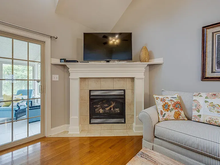 Fireplace with Gas Logs and Sliding Glass Doors to Sunroom