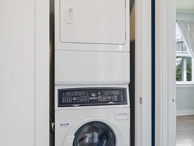 Large pantry (not shown) with a door and separate laundry closet featuring a stackable washer/dryer located on the first floor
