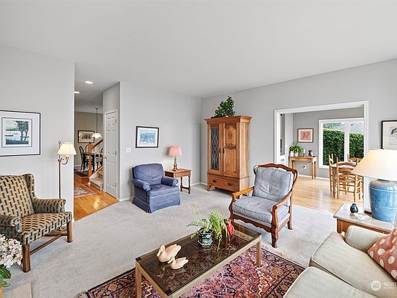 This lovely living space is one of the many focal points of this home.  Close to the kitchen and formal dining room this area gives you and your guests a warm and cozy place to connect, enjoy their company and, Oh the Views!>