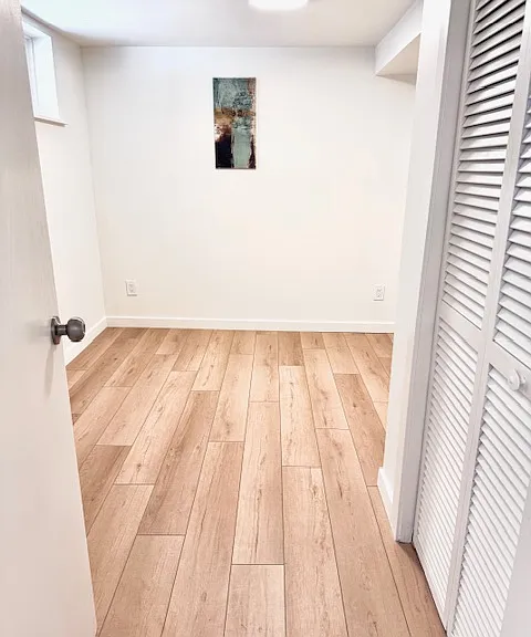 Bright bonus room C, 90 sqft. with wall art. Window facing south back yard.