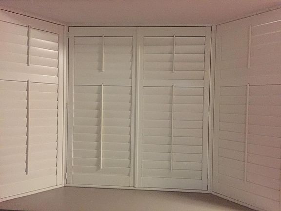 Downstairs bay window with plantation shutters