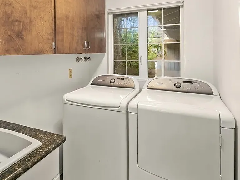 Large laundry room with sink, washer, and dryer.