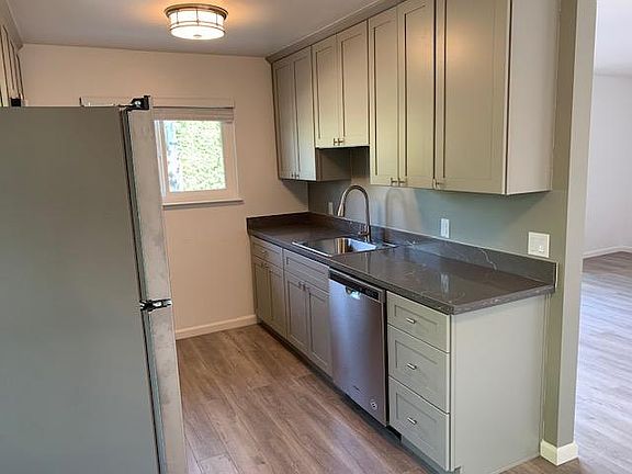 Remodeled kitchen. New cabinets, appliances, windows floors, and counter tops.