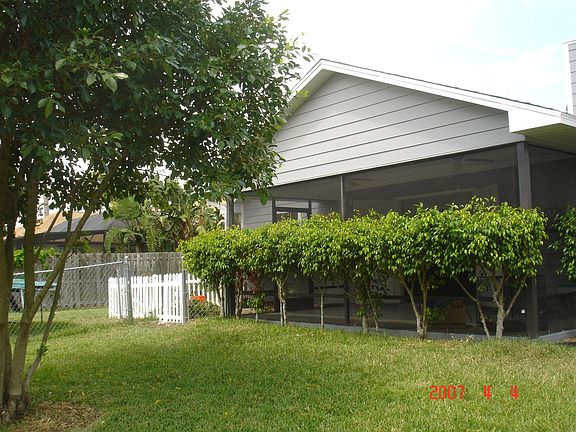  PRIVATE SCREEND BACK PORCH SHADED BY FICUS BUSHES