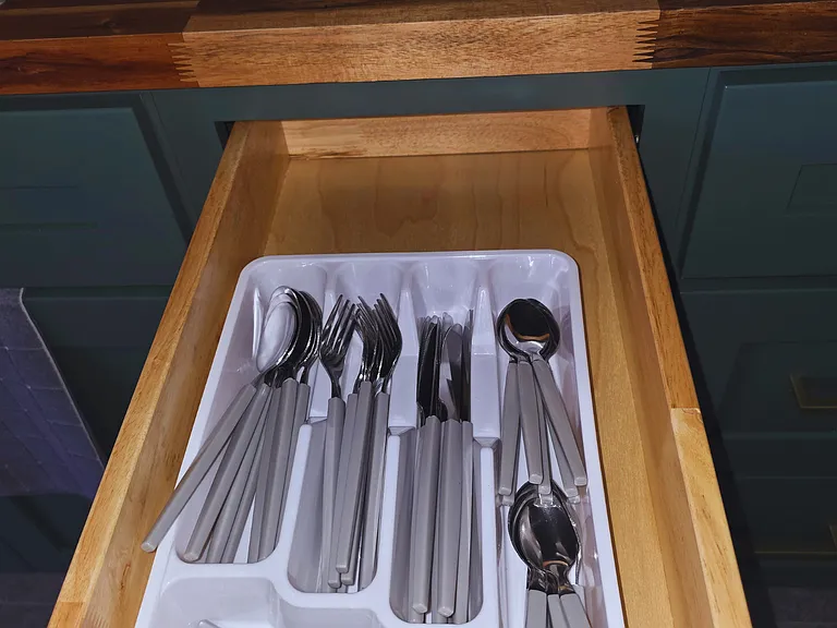 Fully stocked with spoons, forks and knives for your convenience.