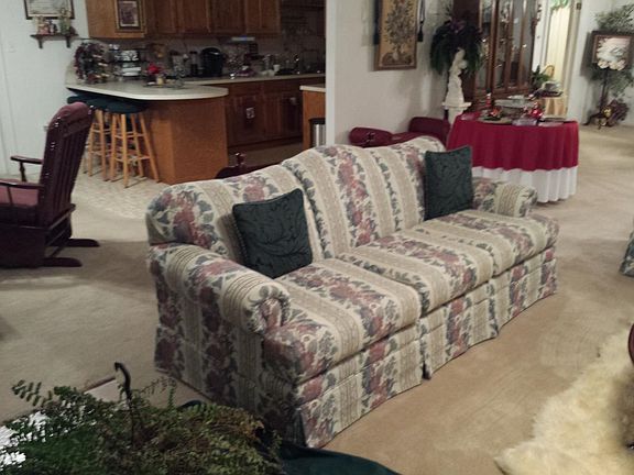 Looking from foyer across living area toward galley kitchen.