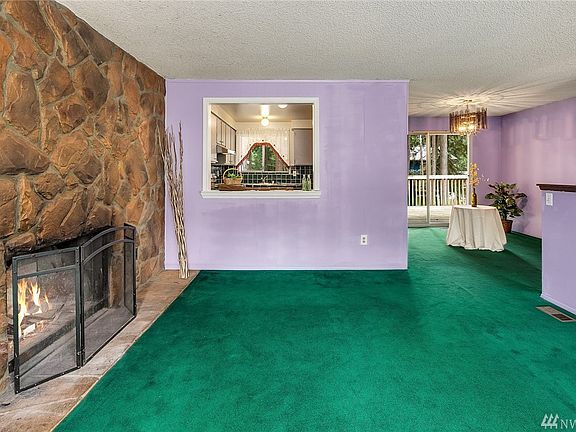 Shows the layout of the living room, kitchen, and dining area.  The sliders in the dining area open to a large entertainment deck.
