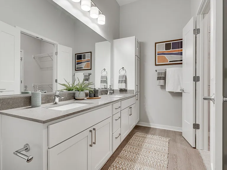 Unwind in your spa-inspired bathroom with dual vanities and French doors.