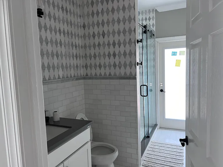 Full bath (powder room) off of kitchen and use by Queen bedroom, access to pool