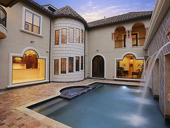 Lavish courtyard heated pool with view of the whole house.