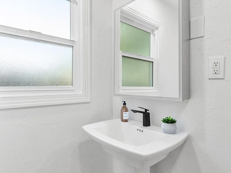 Dimmable, LED-lit mirrored medicine cabinet.