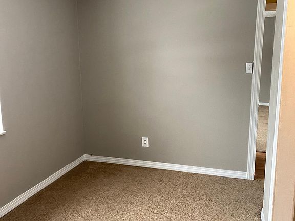 This is a picture of one of the bedrooms with a good size closet to the right.