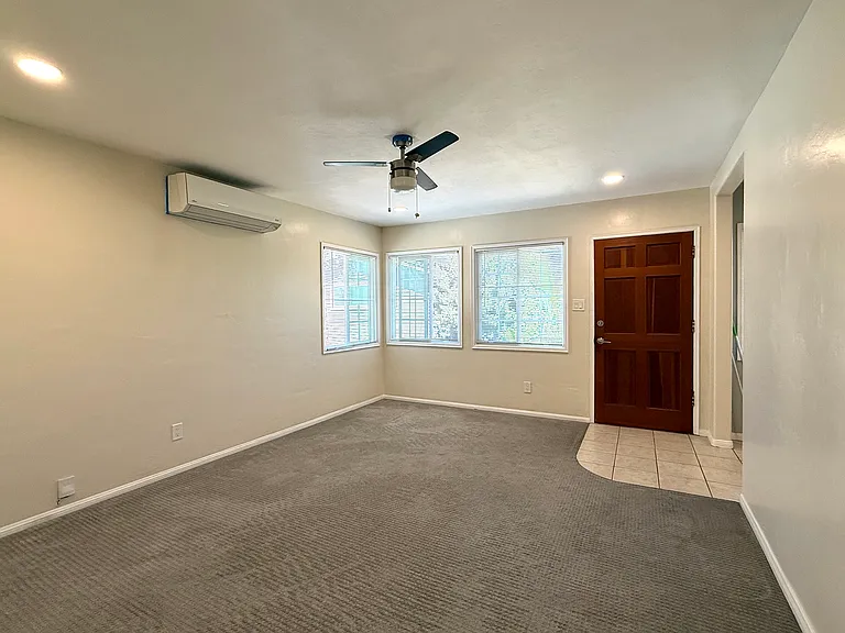 Living room and entry, looking east from the bedroom door.