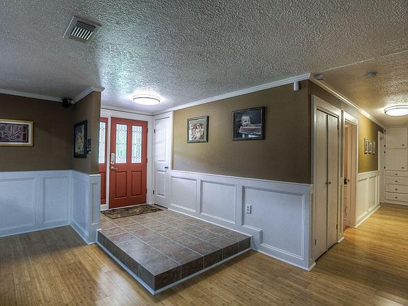 Wide entry with tile flooring and wainscoting
