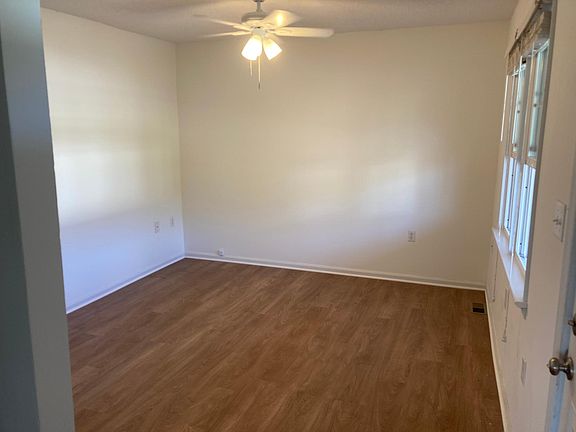 Living room has new ceiling fan, fresh paint, and luxury vinyl flooring.