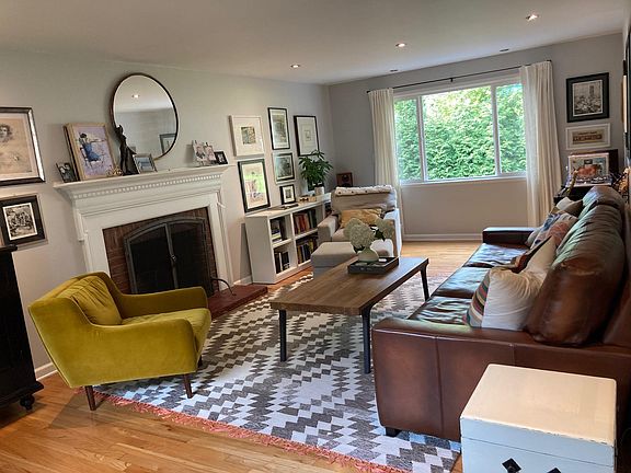 Large living room with a charming fireplace and 2 windows