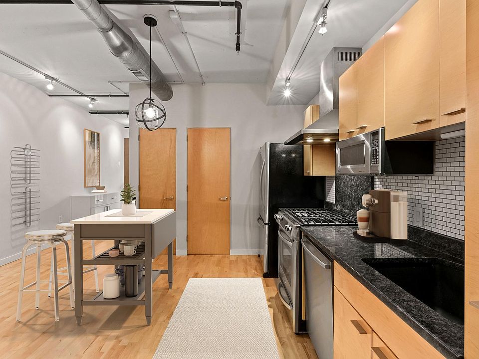 Kitchen/dining with stainless steel appliances, granite countertops, and in-unit washer-dryer