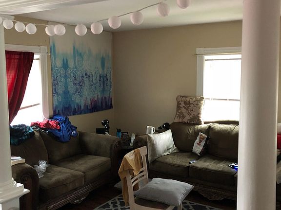 Open concept living area on the second floor. Two rooms that could serve as a dining area and living room.