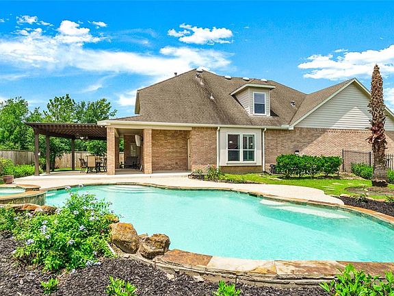 A view of the yard, covered patio, pool & spa, yard, and open space.
