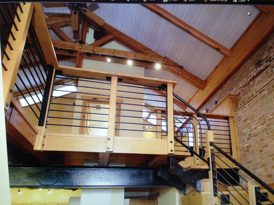 Post industrial look with massive beams, metal railing, bric
