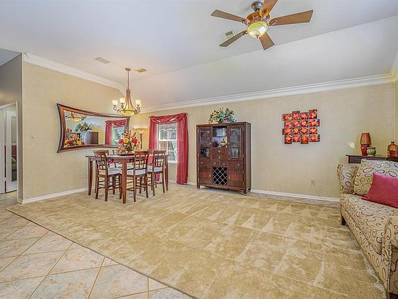 Formal living and dining room with crown molding
