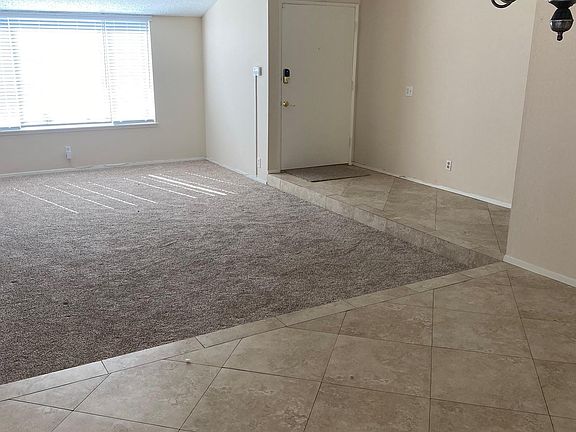 Dining room looking into living room and front door