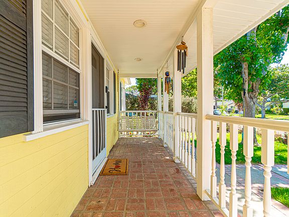 Porch Front of house. Fence all around front yard and outdoor swing.