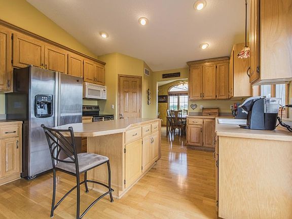 Kitchen has loads of cabinets, counter space, center island, pantry, stainless appliances.