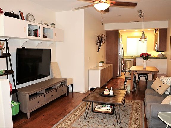 Great room concept. Hardwood flooring,ceiling fan, open and airy.
