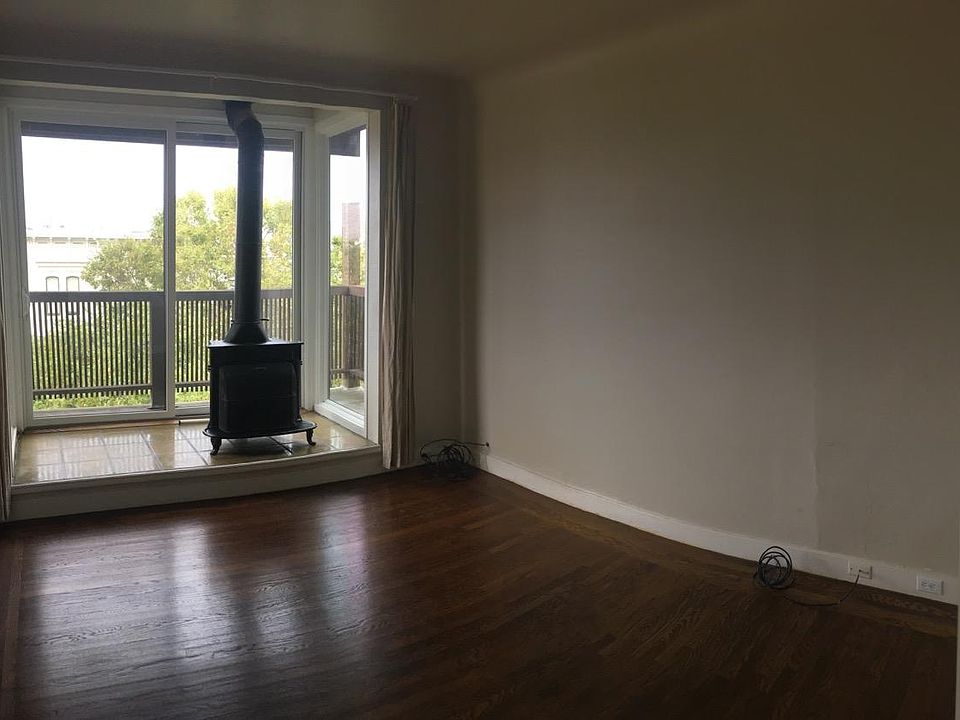 Living/Dining Room with balcony & wood-burning stove.