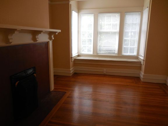bedroom with a fireplace and bench seat