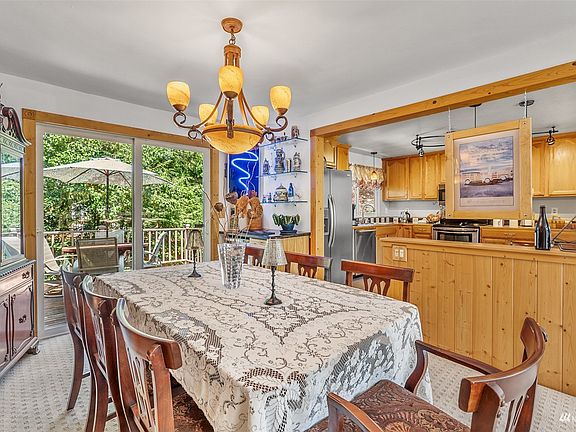 The kitchen has been modified to open up all the spaces between the Living Room, Dining Room, and Kitchen. A sliding glass door off the Dining area is a quick escape to your semiprivate backyard oasis.  Look at all the beautiful pine millwork that wraps windows and doorways.>