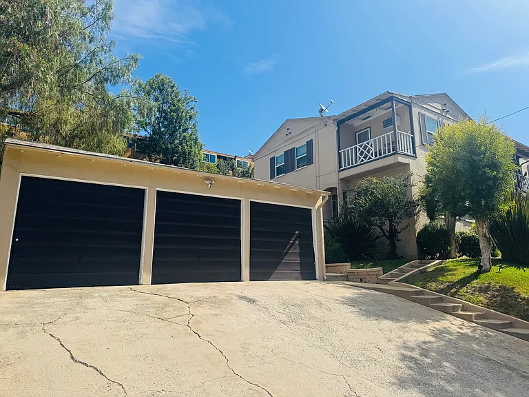 each of the three apartments have a private garage and two tandem parking spots in the driveway