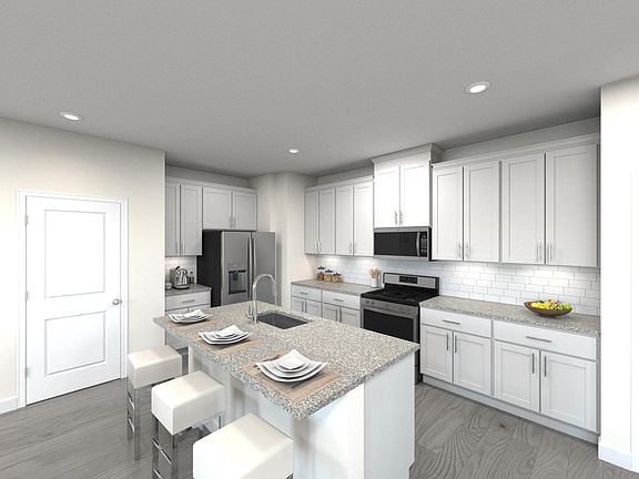 The Lennon s spacious kitchen boasts walk-in pantry and large kitchen island.