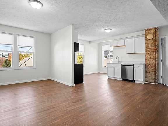 Open concept kitchen with brick detail.