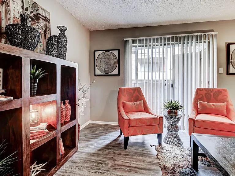 Large living room with lots of natural light and hardwood style floors