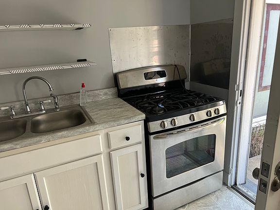 Kitchen. Back door to fenced in yard/ rear parking.