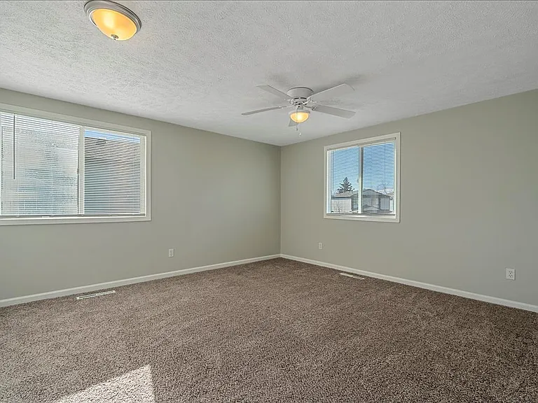 Large master bedroom with lots of natural light.